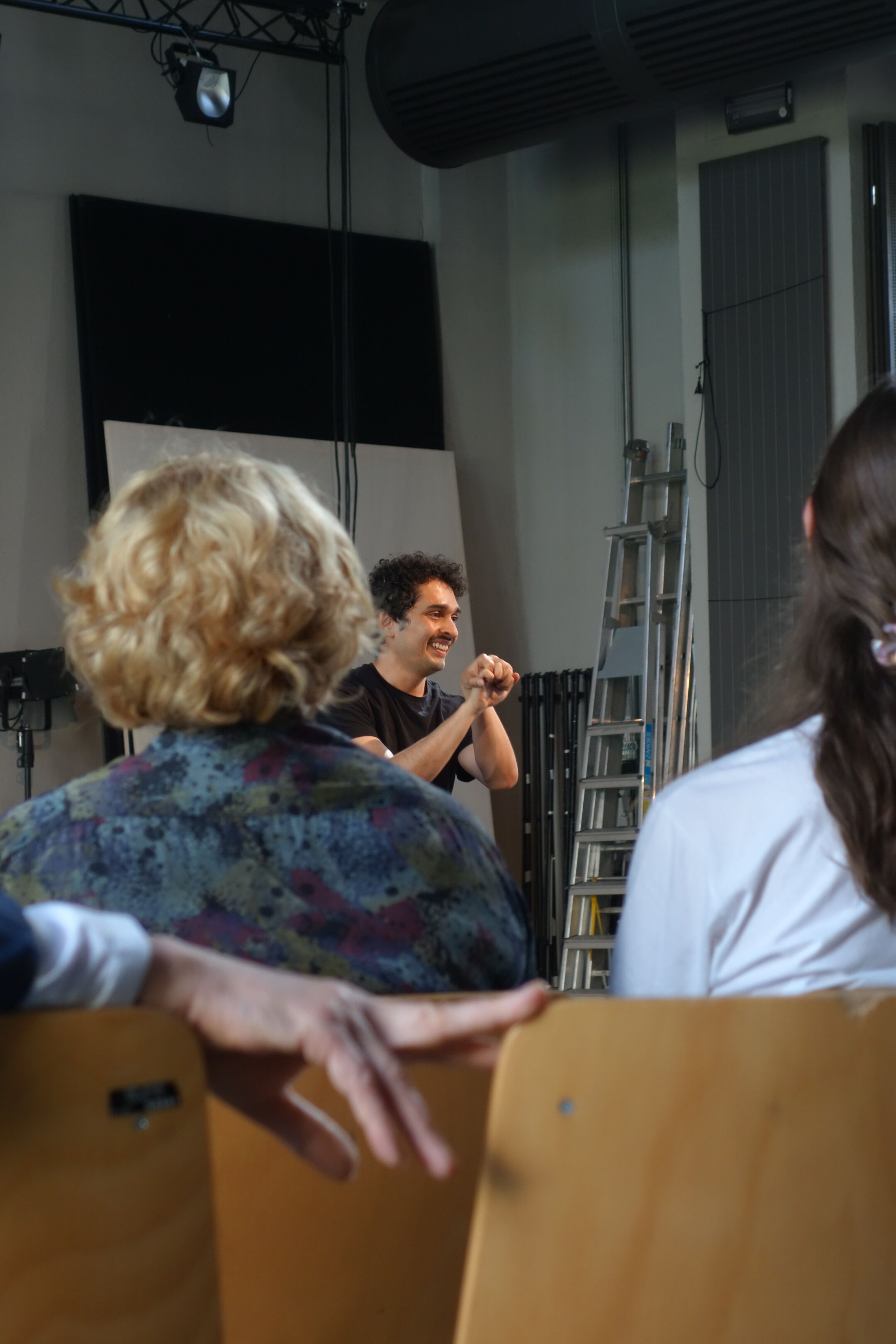 Performance aus Sicht des Publikums, das in einem Theater sitzt.