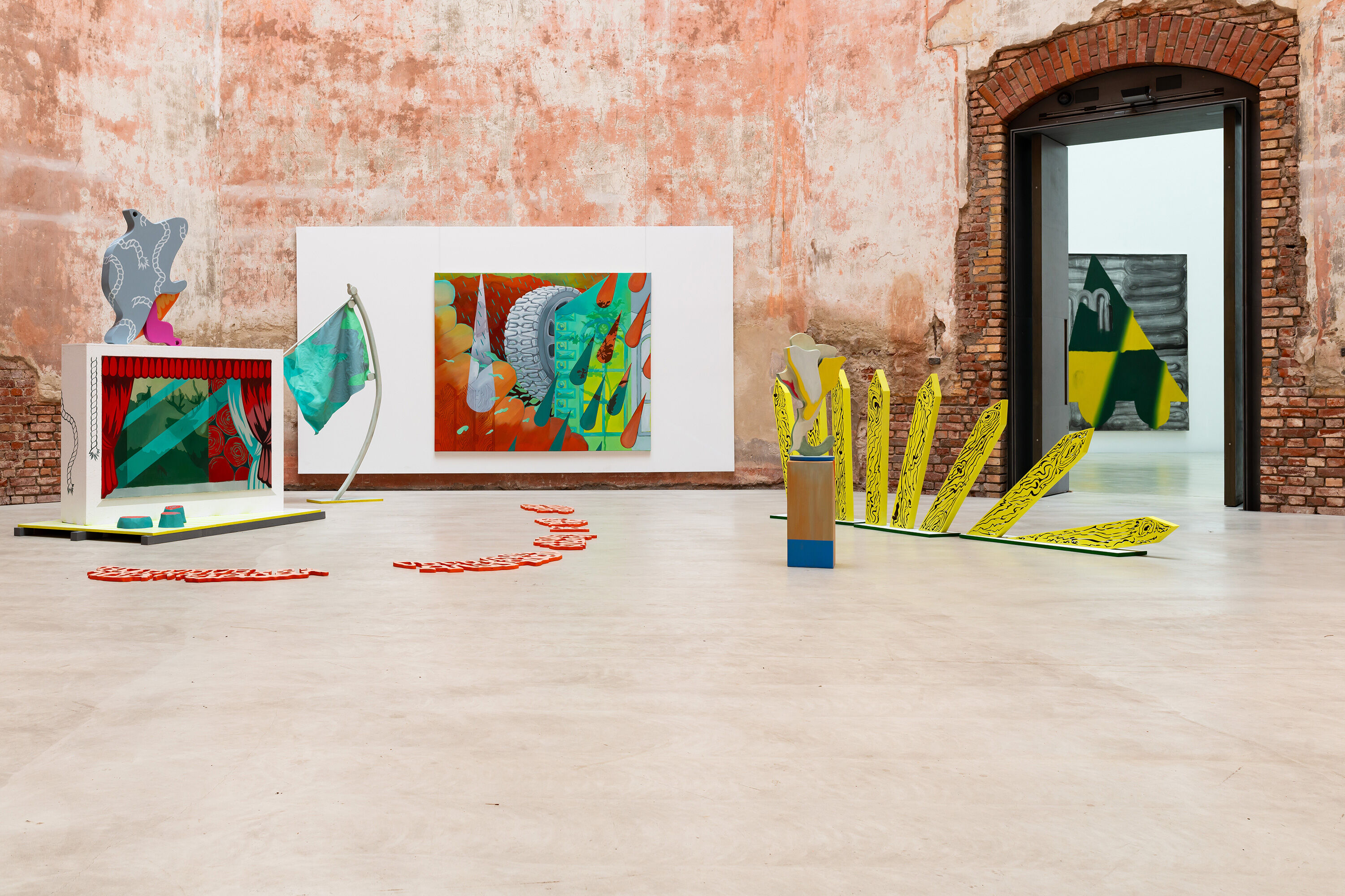 bunte Formen aus Holz vor den roten Backsteinwänden im Oktogon